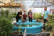 Brett, Trisha, and Bryce look at all the selections of koi.