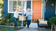 Jasmine (L) and Betsy (R) help each other carry a gold coffee table out to the lounge area where they will add refreshing beverages and lively plants.