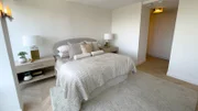 Interior shot of main bed. Walls painted white, white oak herringbone floors, and main bath situated so as to not bleed into bedroom like before. After 16, as seen on Windy City Rehab, Season 4.
