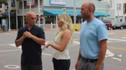 Host Anthony Melchiorri, designer Britany Simon, and the lead from their contracting team present the renovated guest room to the owners.