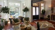 Interior shot of the enclosed front porch. Walls were made of just wood planks for a cabin feel, a new arched door was installed, and dark tile to add to the look. After 6, as seen on Windy City Rehab, Season 4.