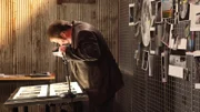 Mike Bara looks at photographs in the war room in D.C.
