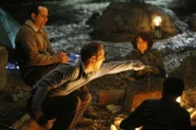 v.li.: Adrian Monk (Tony Shalhoub, li.), Lt. Randall Disher (Jason Gray-Stanford, Brian Willis (Alex Wolff, re.) und die anderen Kinder erzählen sich Geschichten am Lagerfeuer.