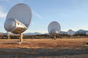 Satellite dishes out in the field.--