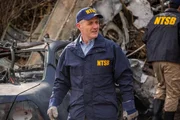 REENACTMENT - The Lead NTSB Investigator (played by Brendan Wall) surveys the wreckage at the crash site of Execuflight 1526. (Cineflix 2020/Darren Goldstein)