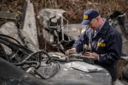 REENACTMENT - The Lead NTSB Investigator (played by Brendan Wall) examines several pieces of wreckage, hoping they will explain what downed Execuflight 1526.
