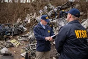 REENACTMENT - The Lead NTSB Investigator (played by Brendan Wall) reviews his notes at the crash site of Execuflight 1526.