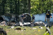 REENACTMENT - NTSB Investigator Joe Sedor (played by Jason Faulkner) and a NTSB Crash Investigator examine the wreckage of downed Comair Flight 5191 and inspect closely one of the turbine engines.