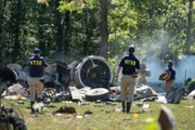 REENACTMENT - NTSB Investigator Joe Sedor (played by Jason Faulkner) and a NTSB Crash Investigator walk towards the wreckage of downed Comair Flight 5191.
