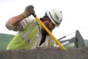 Ben Hudack digging in hopper