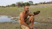 Ed Stafford holding a tortoise shell in his hand in Namibia.