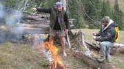 Joe Teti finishes showing Cody Lundin a diagram of a fire balloon.