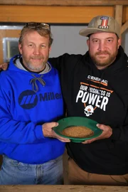 Rick Ness Senior and Rick Ness smiling holding gold pan