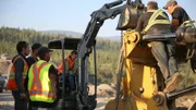 Parker sitting in loader and crew.