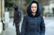 Laura Nix (Kyra Sophia Kahre) wird von einer dunklen Gestalt verfolgt.