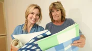 Portait of Grace and Becky looking at wallpaper in the Thinnes house.