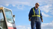 Mike Beets stood next to crane cab