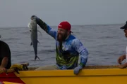 Eric in the canoe holding a fish.