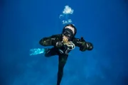 Eric holding an octopus underwater.