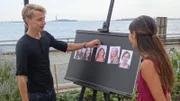Model watches as Face Value game volunteer Leo is shown reaching for the third female face on the game board in order to rank all 5 female faces in his order of attractiveness within 10 seconds.