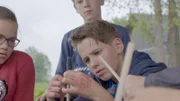 Auch für Alvin ist so ein Devilsstick echt knifflig. Alida und Luca sehen zu.