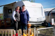 Ines Werner (l) und Simone Weidenbach vor ihrem neuen Wohnwagen.