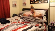 Latonya in bed reading.