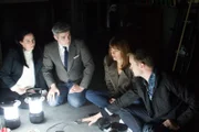Adam Berry points down at an audio recorder with Amy Bruni, Greg Newkirk, and Dana Matthews.