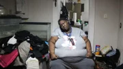 Syreeta on phone in bedroom
