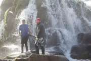 Eric Young (r.) and Jeremy Takala pose at the waterfall.