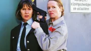 Renate (Marion Reuter) ist völlig durchgedreht, hat Jutta (Claudia Loerding) als Geisel genommen, und will fliehen. Doch die Polizei hat den Weg versperrt...