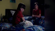 Young twins are in their bedroom.
