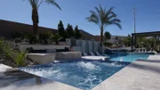 Beautifully finished jucuzzi with bubbles going, eletric fire place, and the pool right next to the jucuzzi, as seen on Pool Kings.