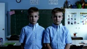 Young twins are in the classroom.