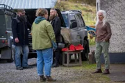 Helen (Danielle Macdonald, 2.v.l.) folgt Elliots Mutter Niamh Cassidy (Olwen Fouéré, r.) nach Hause. Sie muss feststellen, dass die alte Dame von Bodyguards (Komparsen) stets gut bewacht wird.
