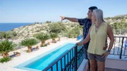 Theresa Hernandez (R) and her husband Lazaro Hernandez (L) pointing at the sea view from one of the houses they view during their house hunt in Crete, Greece, as seen on Mediterranean Life