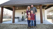 Justin, Jill, Graham (7) and Caroline (4), pose in front of their house, smiling at camera, in El Reno, Oklahoma, as seen on Tiny House, Big Living.