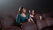 Bonny and her grandmother sitting in a movie theater.