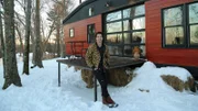 Tiny house builder and owner Sterling Folkestad leans alongside the patio with a huge smile on his face as he cannot believe he is here with his friends and family celebrating the end of this build, as seen on Tiny House, Big Living.