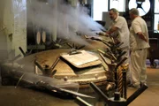 Canned bread factory, a row of machinery emitting steam.