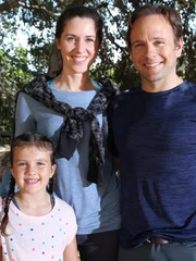 Dale and Stephanie Bruner with their daughter in the woods.