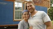 Tyler and Kathrin, builders and soon to be homeowners, smile and pose for the camera in front of the newly completed exterior of their tiny home, in Rossville, Georgia, as seen on Tiny House, Big Living.