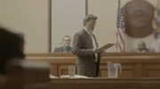 People sit in a court room discussing the case.