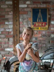 Izzie smiling at the camera holding koala.