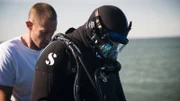 Kris helps brother Andy Kelly prepare to dive.