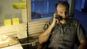 Steve on the phone at the police station where he worked.