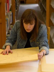 Amy Bruni looks at a map at a library.