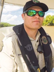 Game Wardens Mike Serbanic and Matt Kiel driving a boat