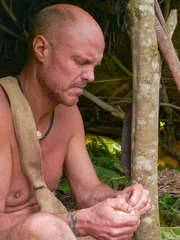Wes peeling fruit in shelter