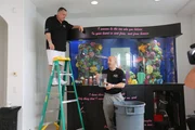 Wayde and Brett put fish in the tank.